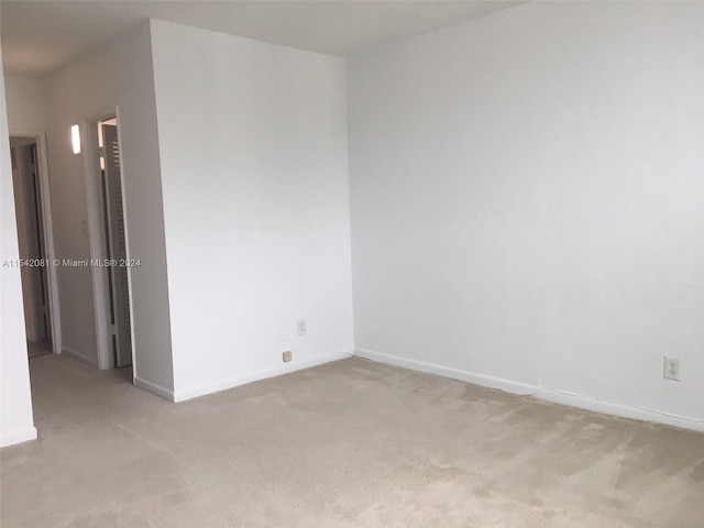 empty room featuring light colored carpet