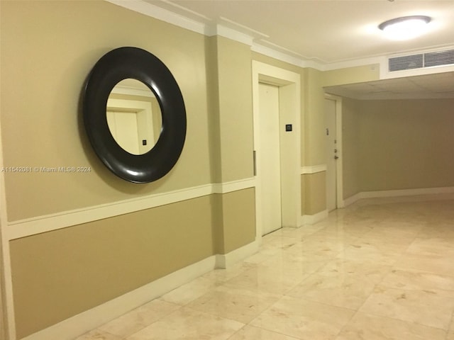 hallway with light tile floors and crown molding