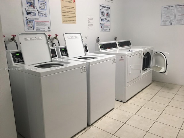 laundry area featuring hookup for a washing machine, light tile flooring, and washing machine and dryer