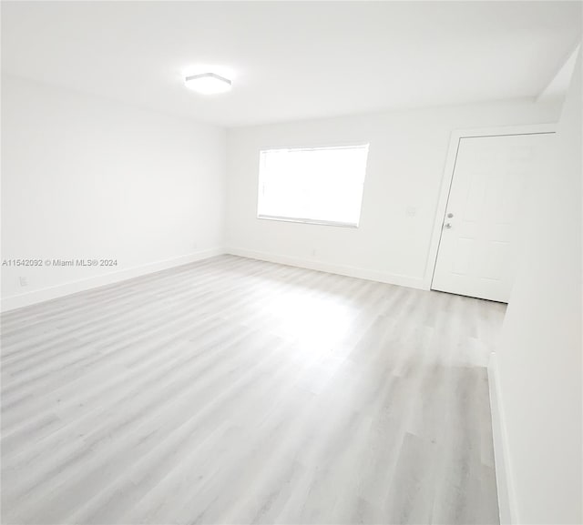 spare room featuring light wood-type flooring