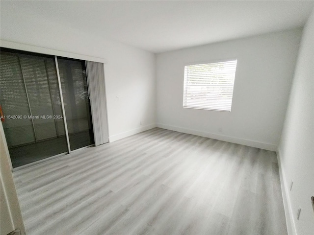 unfurnished room with light hardwood / wood-style flooring