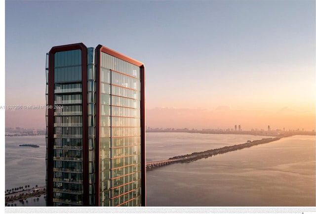 outdoor building at dusk featuring a water view