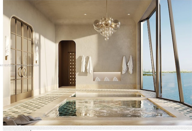 bathroom with a water view and a chandelier