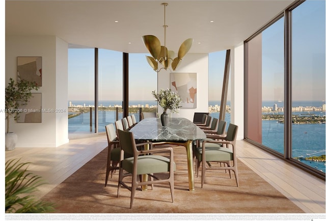 dining area featuring a water view, light hardwood / wood-style floors, ceiling fan, and a wall of windows