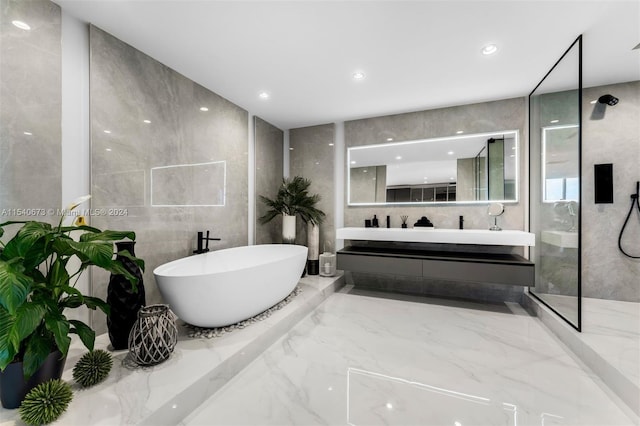 bathroom with tile walls, tile floors, and a bath to relax in