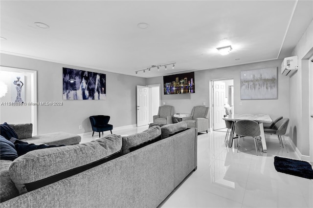 living room featuring light tile floors, track lighting, and a wall unit AC