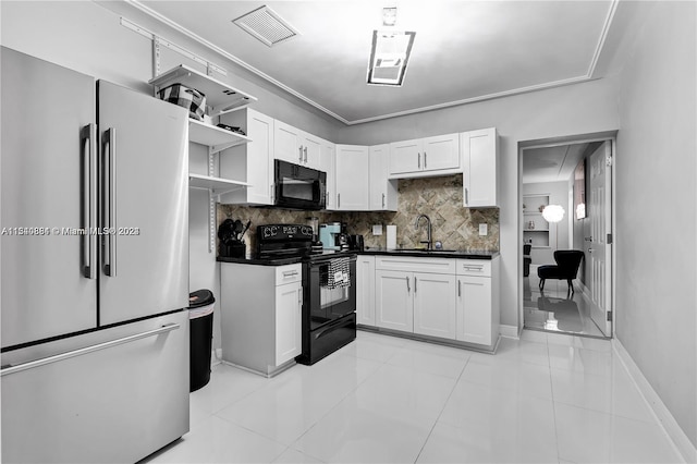 kitchen with sink, backsplash, light tile flooring, black appliances, and white cabinetry