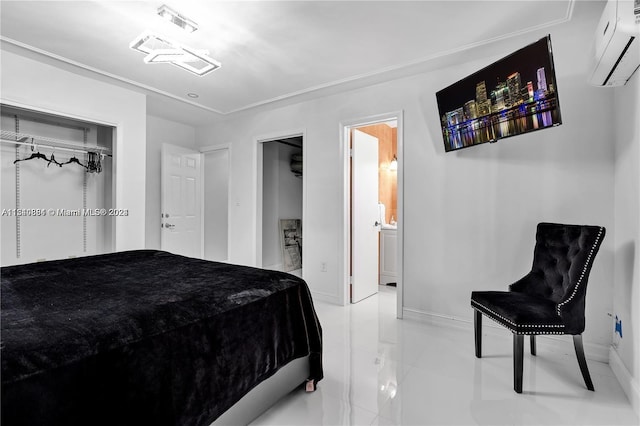 bedroom with a wall mounted AC, a closet, ensuite bath, and light tile floors