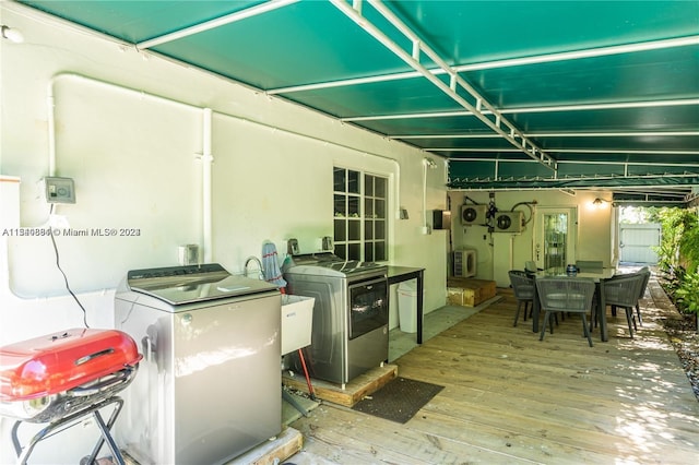 exterior space with a wooden deck and independent washer and dryer