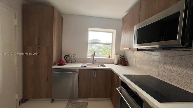 kitchen with decorative backsplash, stainless steel appliances, and sink