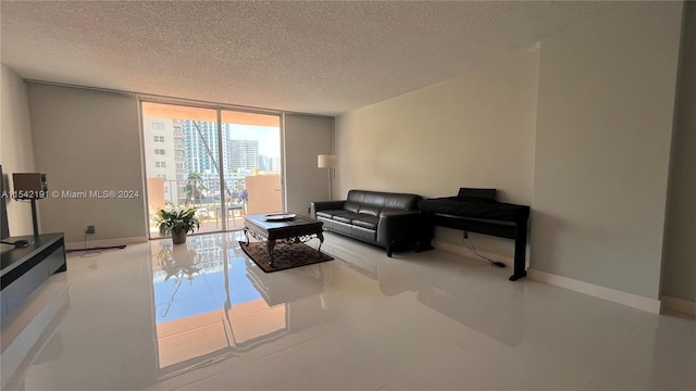 living room featuring floor to ceiling windows and a textured ceiling