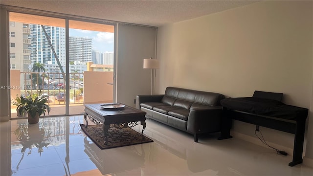 living room featuring a wall of windows and a textured ceiling