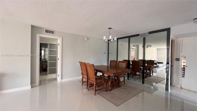 dining room featuring a notable chandelier and a textured ceiling