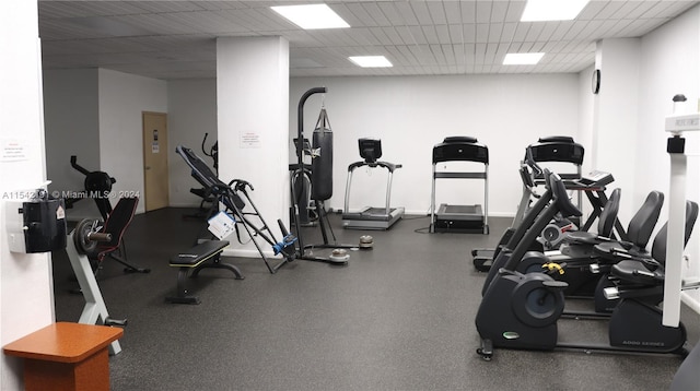 exercise room with a paneled ceiling