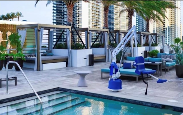 view of swimming pool with an outdoor living space and a patio