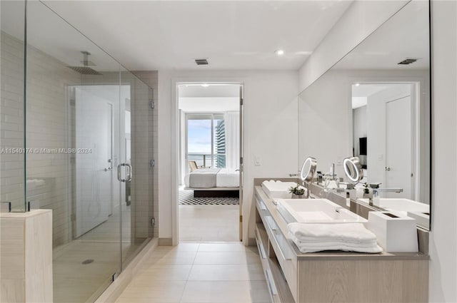 bathroom featuring tile patterned flooring, vanity, and a shower with shower door