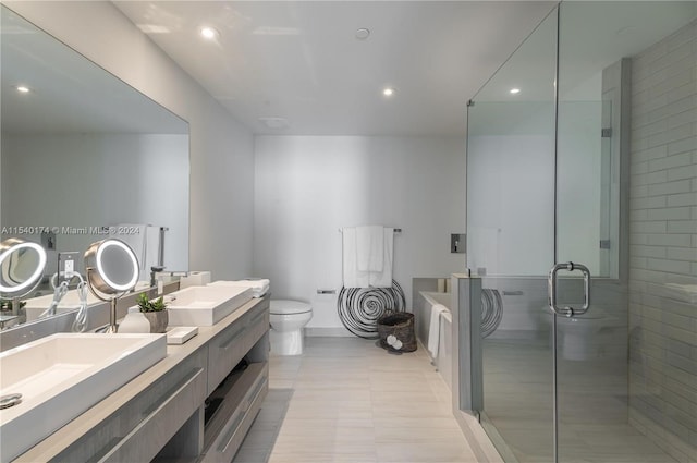 bathroom with walk in shower, vanity, and toilet