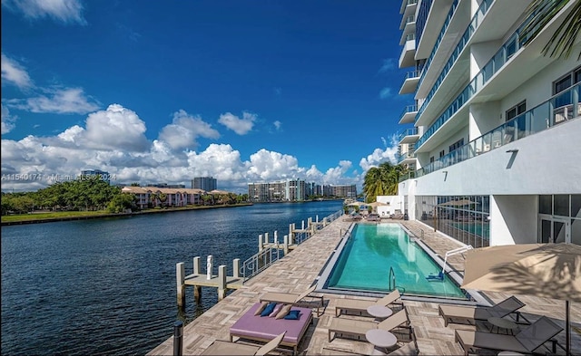 view of pool with a dock and a water view