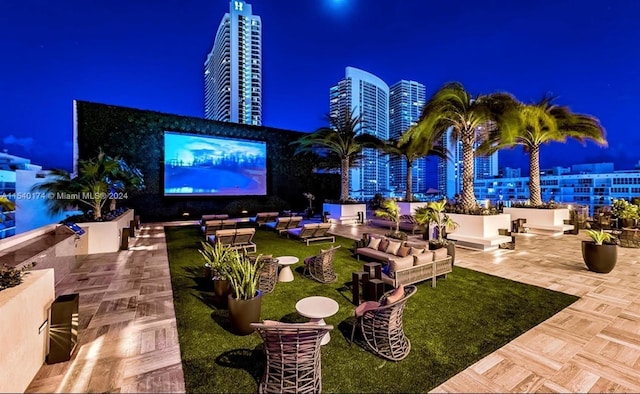 patio at twilight featuring outdoor lounge area