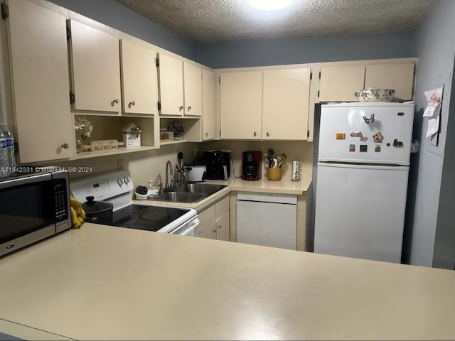 kitchen with white cabinetry, white appliances, a textured ceiling, and sink