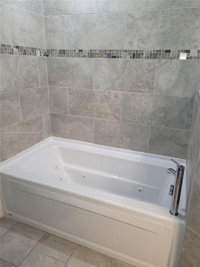 bathroom with a tub and tile patterned floors