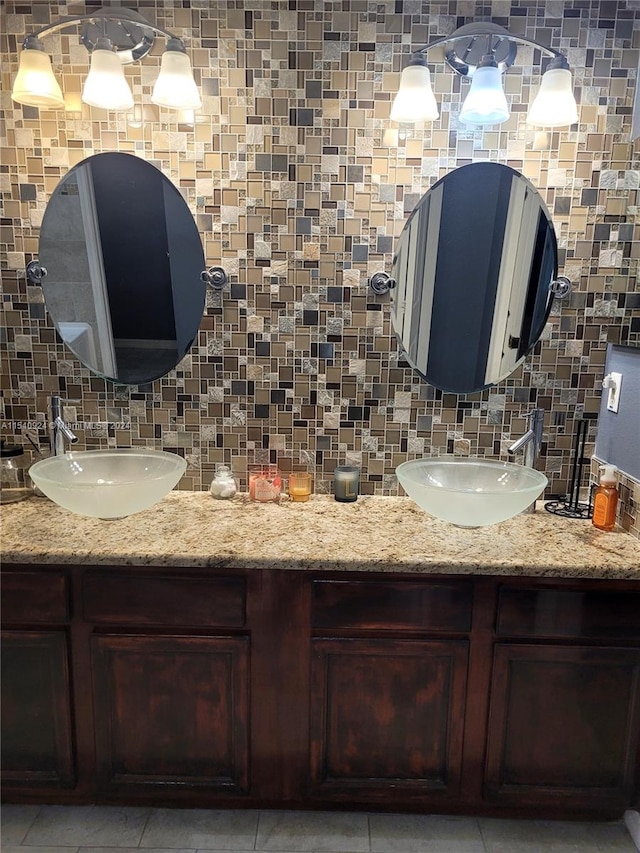 bathroom with vanity, tasteful backsplash, and tile patterned flooring