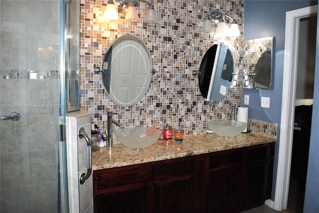 bathroom featuring vanity, backsplash, and walk in shower