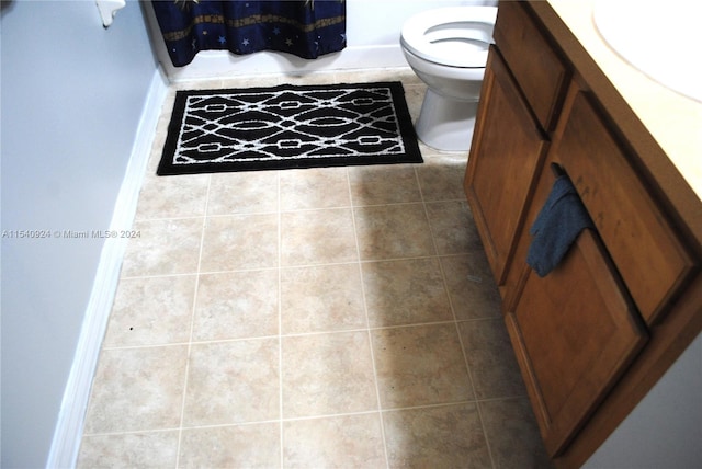 bathroom with vanity, toilet, and tile patterned flooring