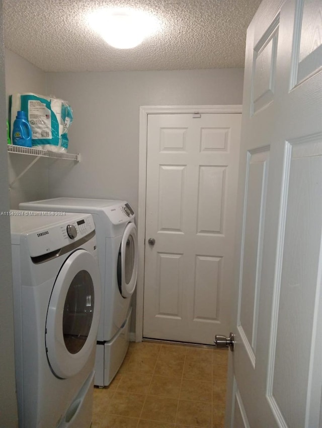 washroom with independent washer and dryer and a textured ceiling