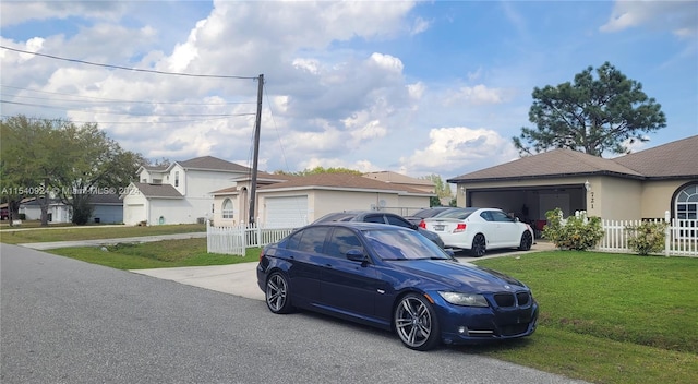 view of front of home with a front yard and a garage