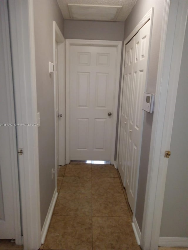 hallway featuring tile patterned flooring