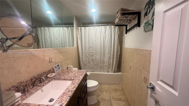 full bathroom with vanity, tile floors, toilet, and tile walls