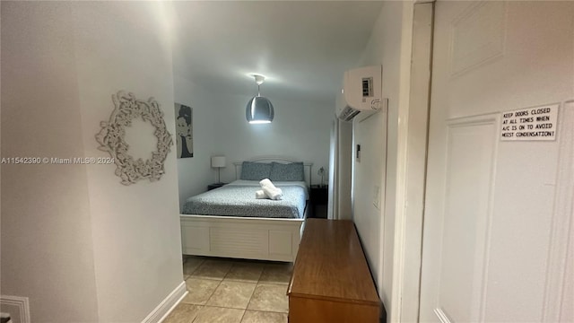 tiled bedroom featuring a wall mounted air conditioner