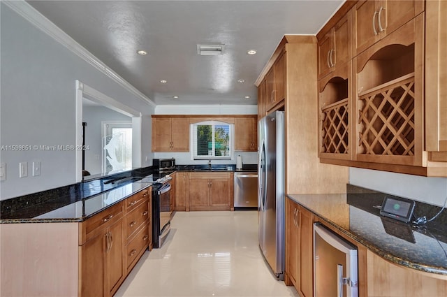 kitchen with stainless steel appliances, beverage cooler, kitchen peninsula, dark stone counters, and ornamental molding