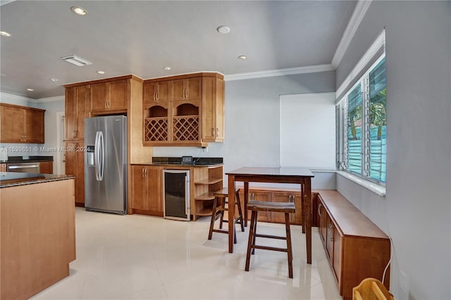 kitchen with stainless steel fridge, light tile patterned flooring, ornamental molding, and beverage cooler