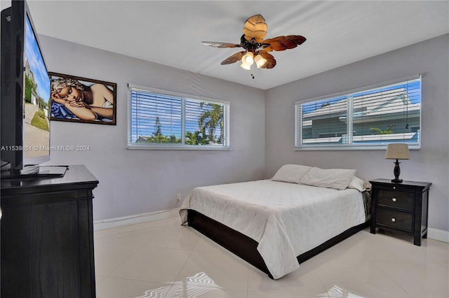 bedroom featuring light tile patterned floors and ceiling fan