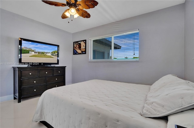 tiled bedroom featuring ceiling fan