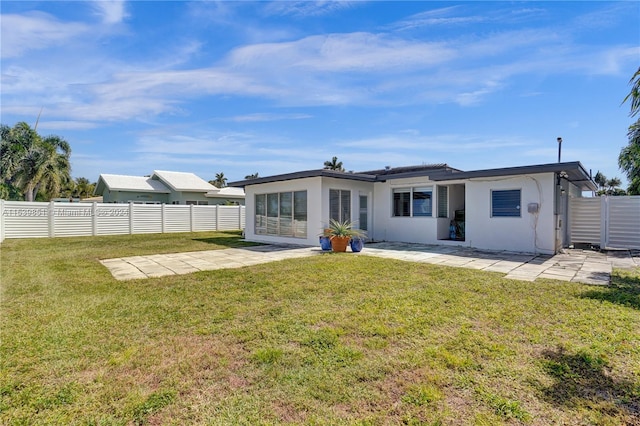 rear view of house with a yard