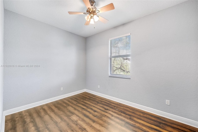 empty room featuring ceiling fan and dark wood-type flooring