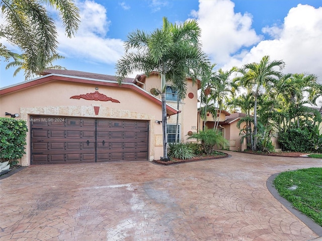 mediterranean / spanish-style home featuring a garage