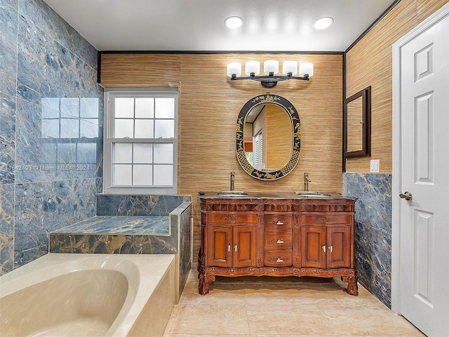 bathroom featuring dual bowl vanity, tile floors, tile walls, and tiled bath