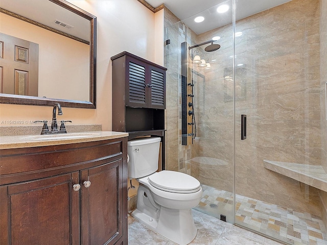 bathroom featuring vanity with extensive cabinet space, a shower with door, toilet, and tile floors