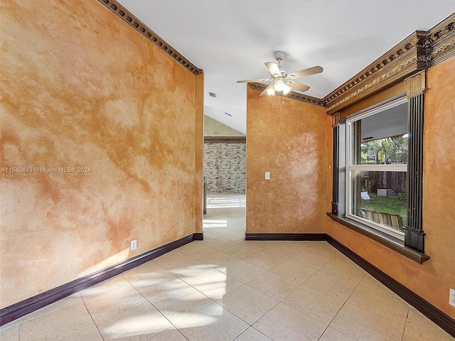 spare room featuring crown molding, ceiling fan, and light tile floors