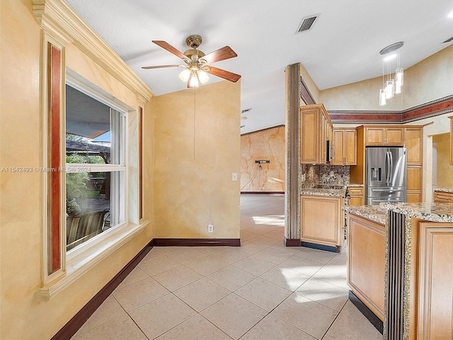 kitchen with light stone countertops, stainless steel fridge with ice dispenser, backsplash, hanging light fixtures, and ceiling fan