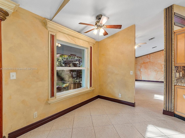 tiled empty room with ceiling fan