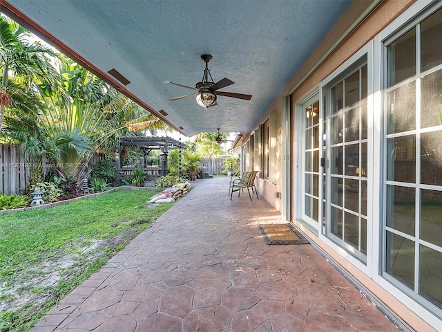 view of patio / terrace with ceiling fan and a pergola