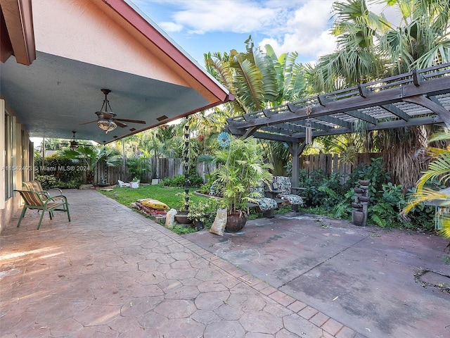 view of patio / terrace with ceiling fan and a pergola