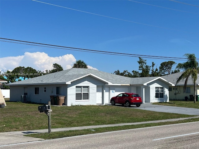 ranch-style home featuring a front lawn and a garage