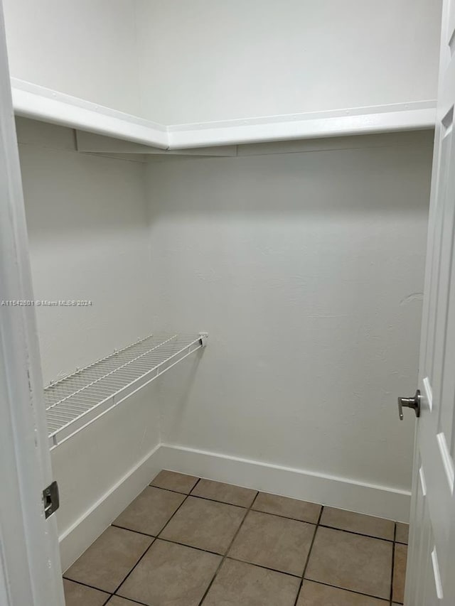 walk in closet featuring tile floors