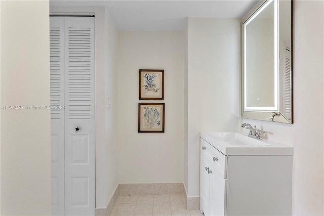 bathroom featuring vanity with extensive cabinet space and tile floors